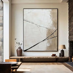 Abstract painting in a modern living room with stone walls and wooden bench.
