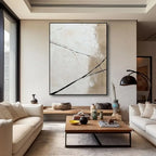 Modern living room with abstract art, white sofas, and a wooden coffee table.
