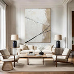 Modern living room with abstract art, white sofa, and wooden coffee table.
