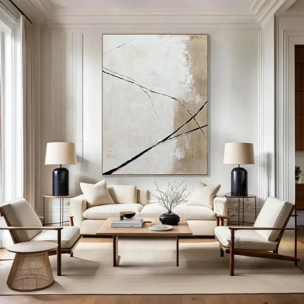 Modern living room with abstract art, white sofa, and wooden coffee table.