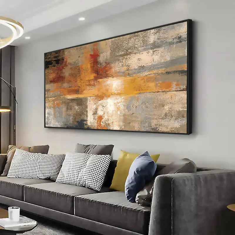 Gray sectional sofa with colorful pillows in a living room setting, featuring a large abstract painting on the wall.