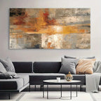 Living room with a large abstract painting above a gray sectional sofa.