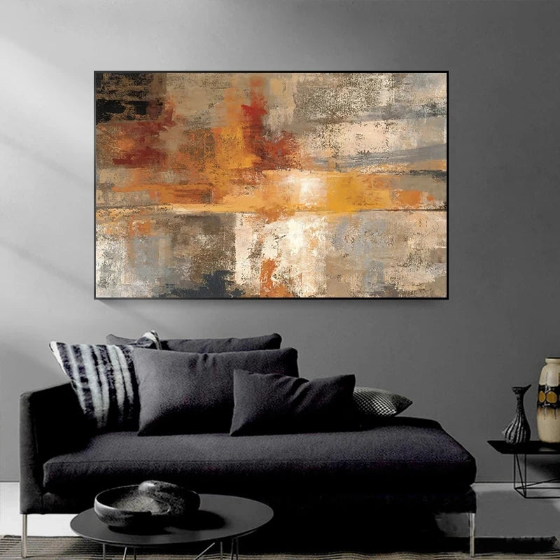 Abstract art painting on a gray wall above a black sofa with decorative pillows.