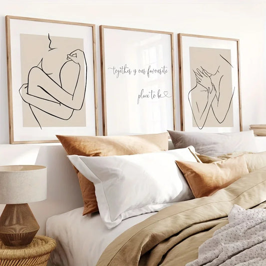 Decorative wall art above a bed with pillows and a lamp.