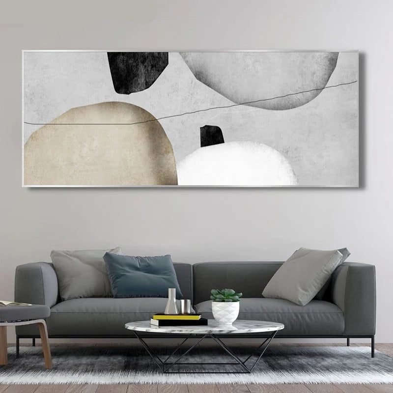 Abstract art piece on a wall above a gray sofa in a living room.