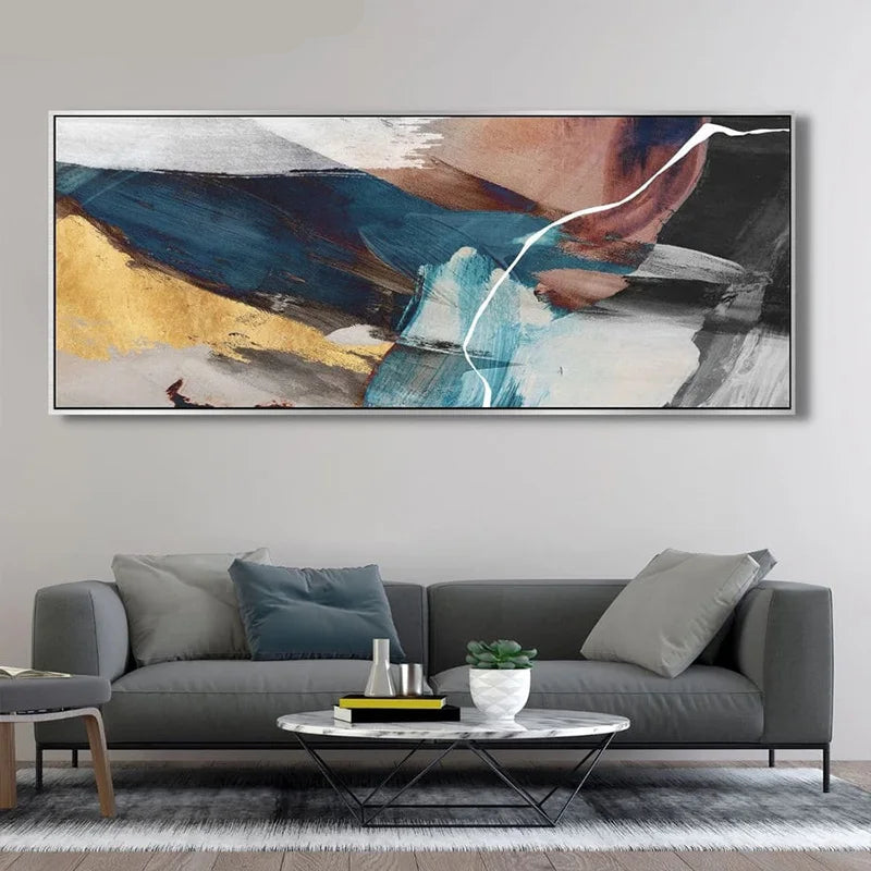 Abstract painting on a wall above a gray sofa in a living room.