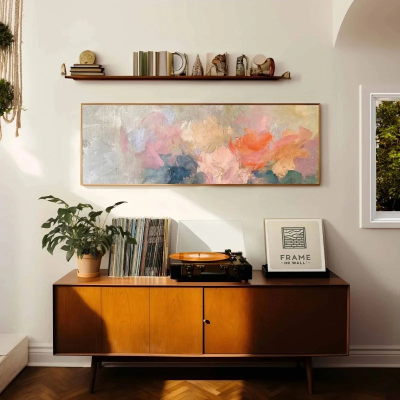 Living room with wooden sideboard, abstract floral painting, and record player.