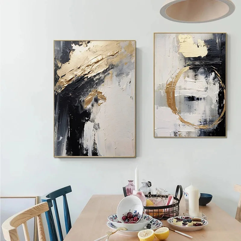 Two abstract paintings on a wall above a dining table with fruit and candles.