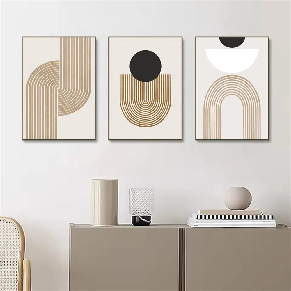 Three abstract art prints on a wall above a cabinet with decorative items.