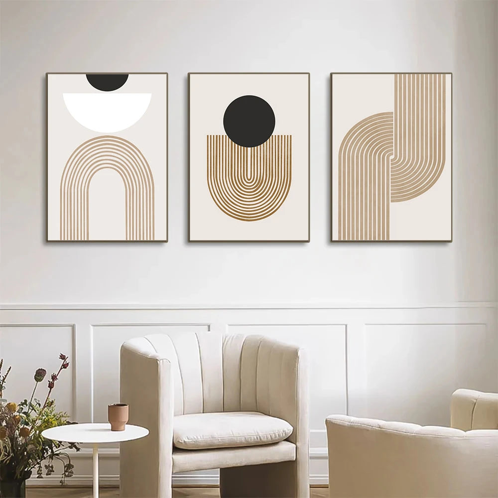 Three abstract art pieces on a wall above a sofa in a living room.