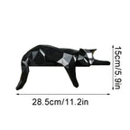 Black geometric cat figurine with measurements on a white background