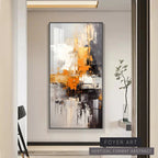 Abstract art painting in a modern interior setting with a plant.