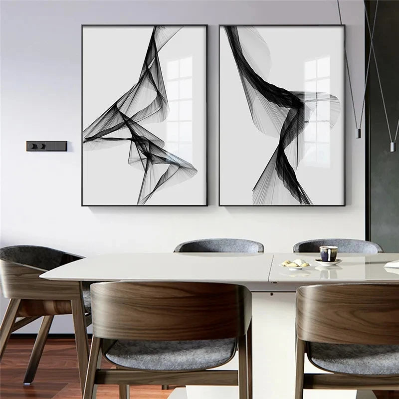 Dining room with abstract black and white wall art above a table.