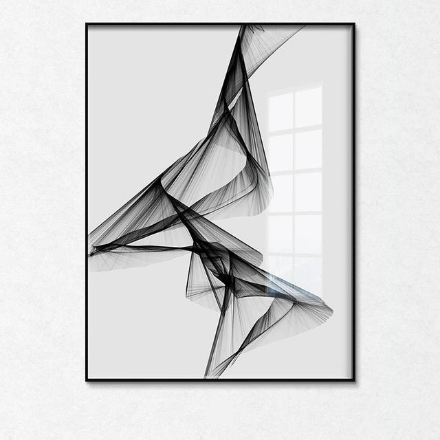 Abstract black and white art print in a black frame on a white wall.