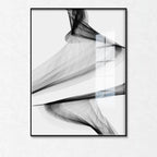 Abstract black and white art print in a frame on a white wall