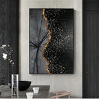 A vertical canvas wall art print featuring a black and gray wood grain leaf design with a wavy gold border and white speckled texture on a black background, displayed in a modern dining room setting.