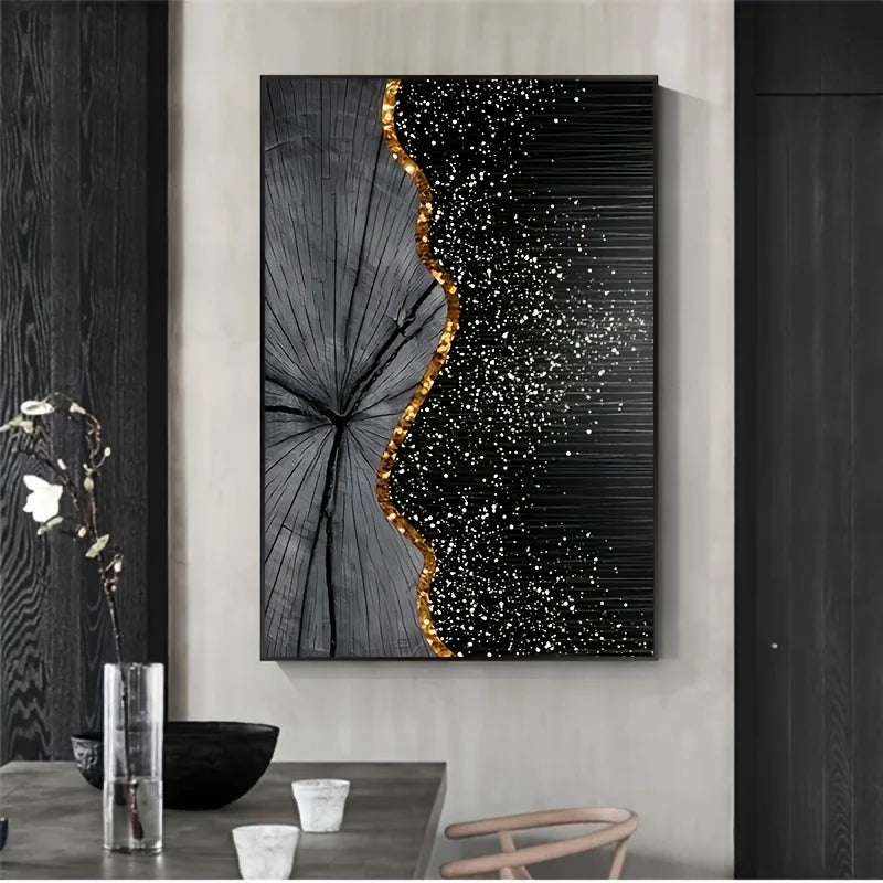 A vertical canvas wall art print featuring a black and gray wood grain leaf design with a wavy gold border and white speckled texture on a black background, displayed in a modern dining room setting.