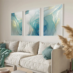Three abstract wall art pieces above a white sofa in a living room.