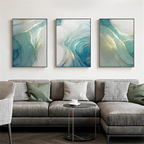 Gray sectional sofa with decorative pillows in a living room setting, featuring abstract art on the wall.