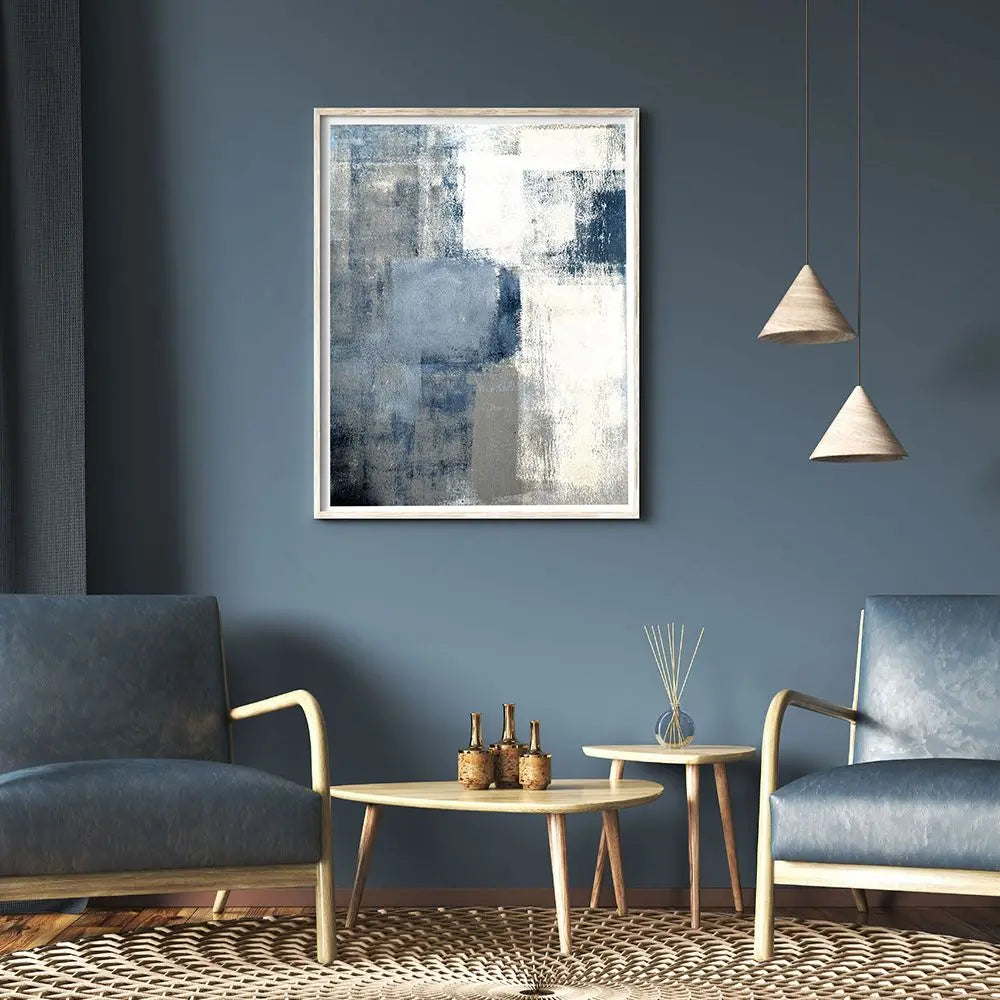 Modern living room with abstract art, blue chairs, and a coffee table.