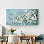 Dining room with a large floral painting on the wall above a wooden table.