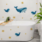 Bathroom with whale wall decals on a white bathtub and wall.
