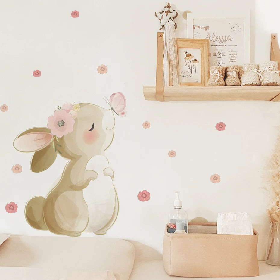 Decorative wall sticker of a cartoon squirrel with a flower on a wall with small pink flowers.
