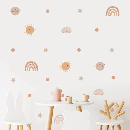 Children's room with wall decals of suns, moons, stars, and rainbows above a small table and chairs.