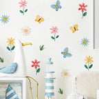Decorative wall stickers of flowers, butterflies, and a lighthouse on a white wall.