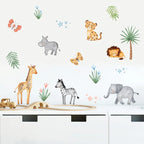Jungle animal wall stickers on a white surface with a toy train track.