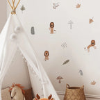 Children's room with a white teepee, stuffed animals, and wall decals of lions and plants.