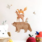 Woodland animal wall decals on a light background with soft toys around.