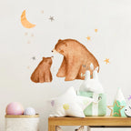Children's room decor with bear wall stickers and toys on a shelf.