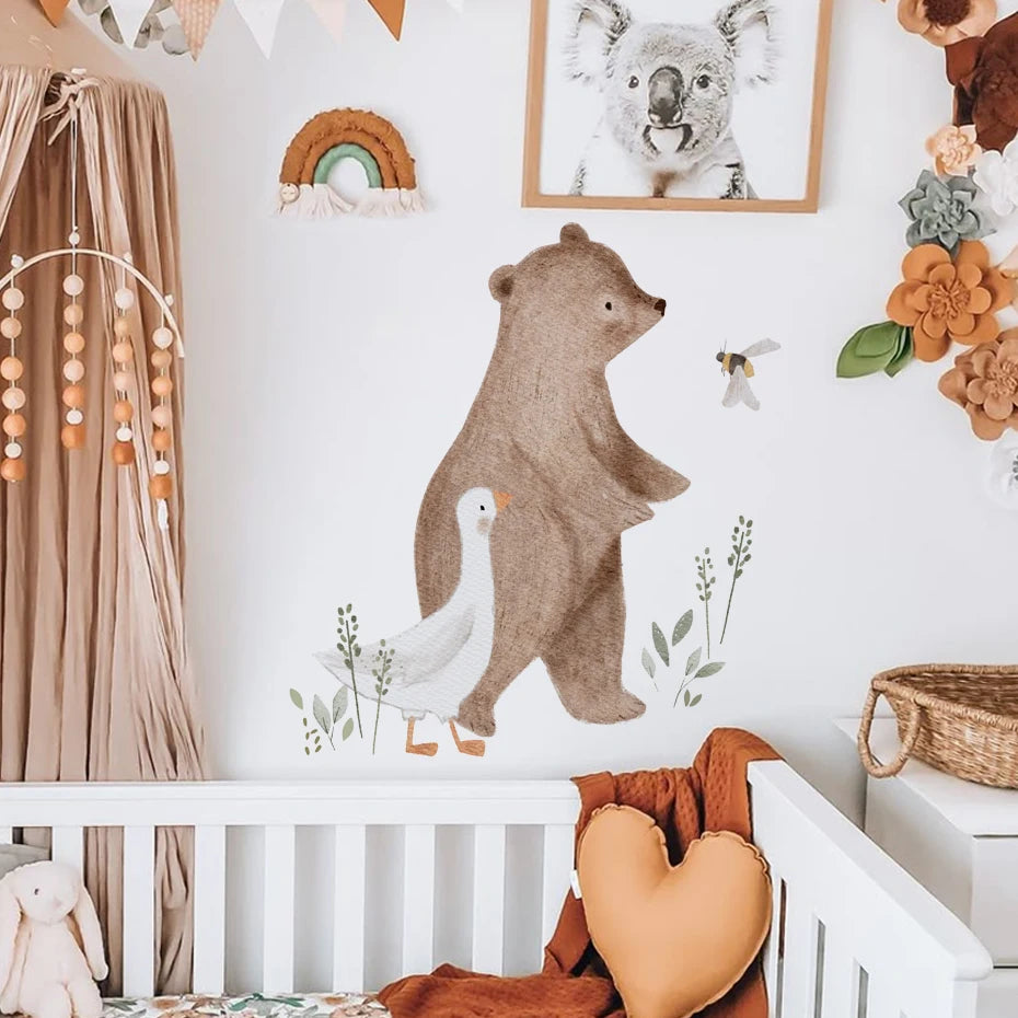 Nursery room with bear and duck wall decal, floral decorations, and a crib.