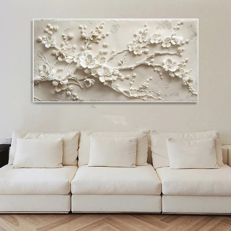 White floral wall art above a beige sofa in a living room.
