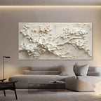 Decorative wall art of white floral branches in a modern living room.