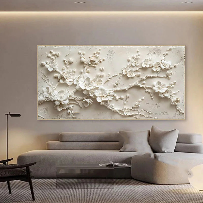 Decorative wall art of white floral branches in a modern living room.