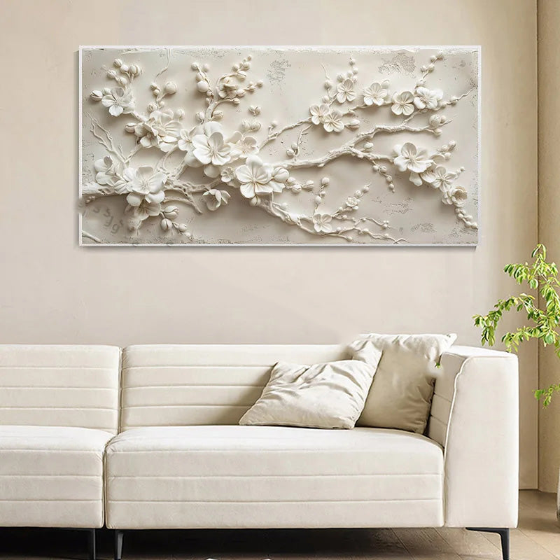 Decorative wall art with floral design above a white sofa in a living room.