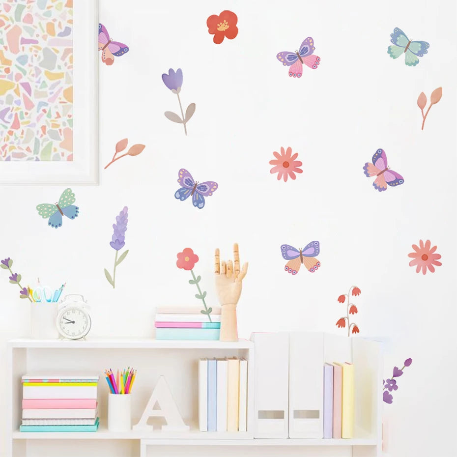 Wall with colorful butterfly and flower decals above a white shelf with books and stationery.