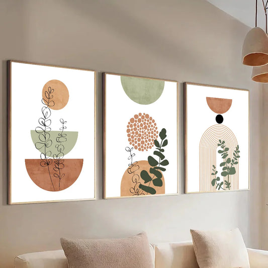 Three abstract wall art pieces on a wall above a sofa.
