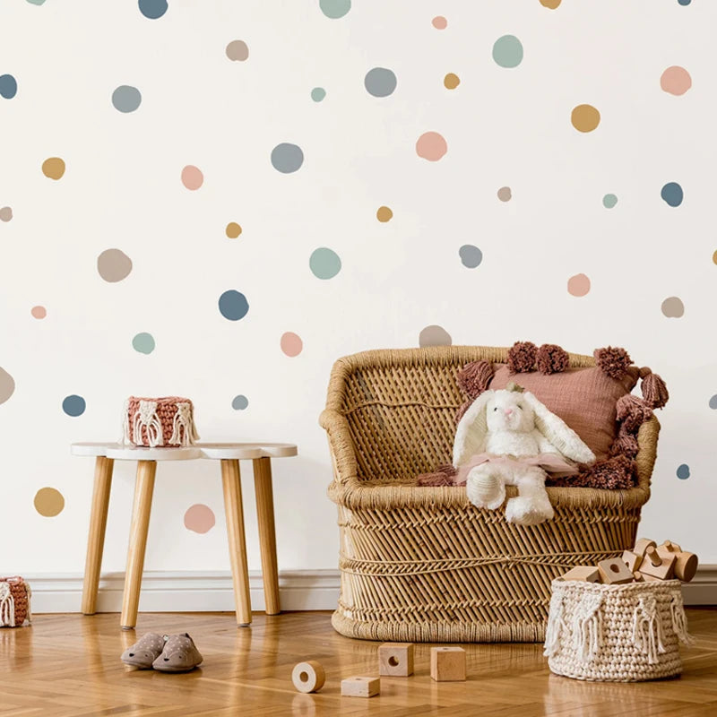 Children's room with wicker chair, polka dot wall, and toys.