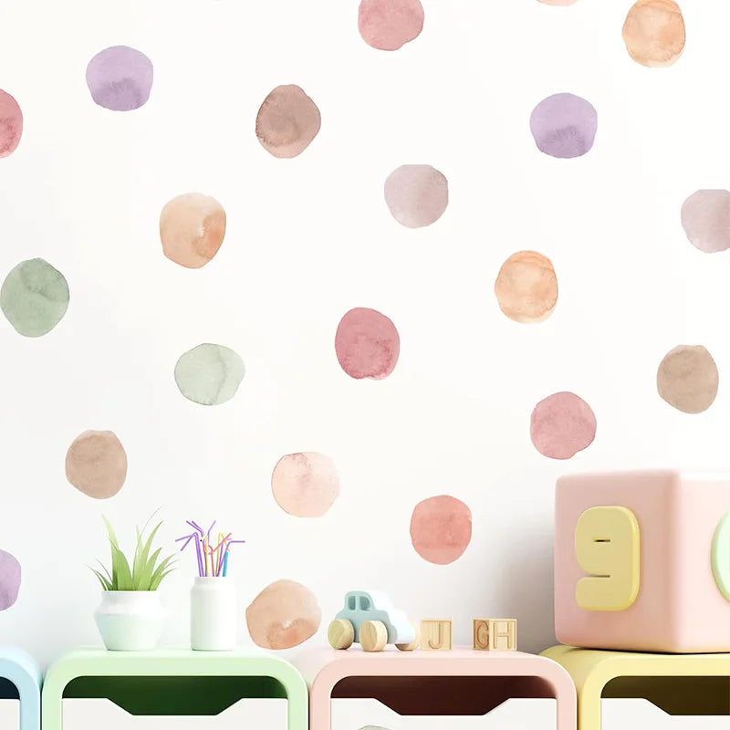Colorful polka dot wall decal on a light background with children's toys below.