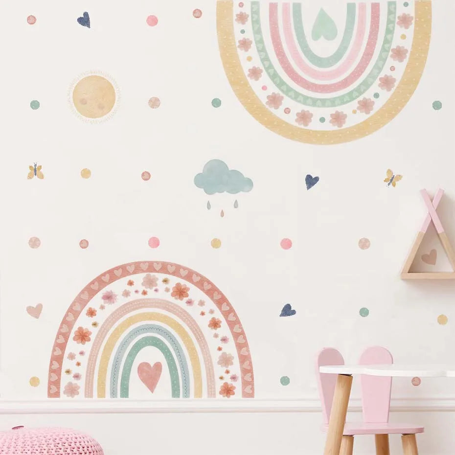 Children's room with pastel rainbow and cloud wall decals on a white wall.