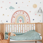 Children's room with a crib, decorative wall stickers, and a lamp.