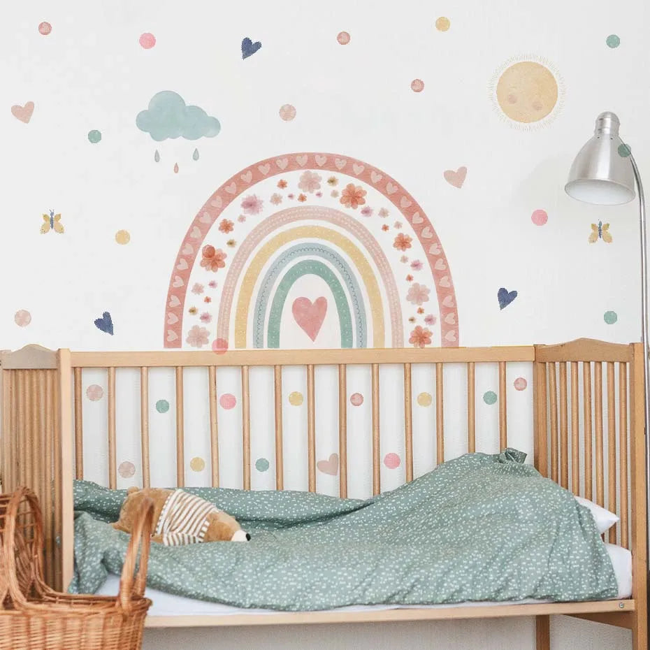 Children's room with a crib, decorative wall stickers, and a lamp.