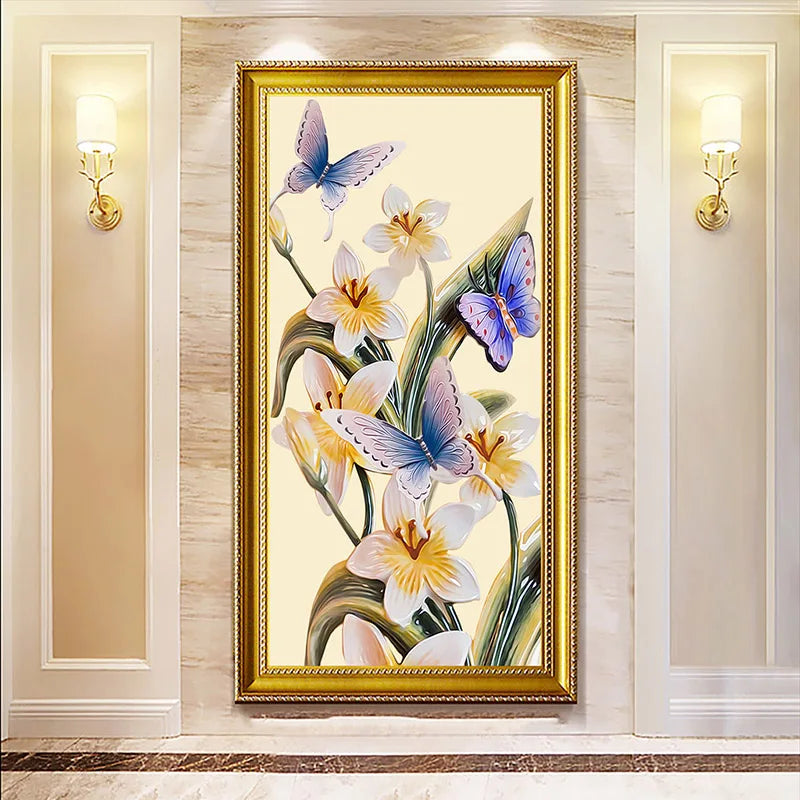 Decorative painting of flowers and butterflies in a gold frame on a wall.
