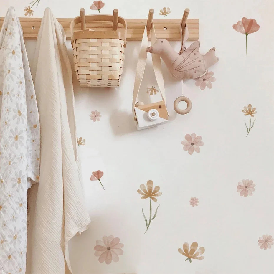 Children's room with floral wallpaper, hooks, and decorative items.