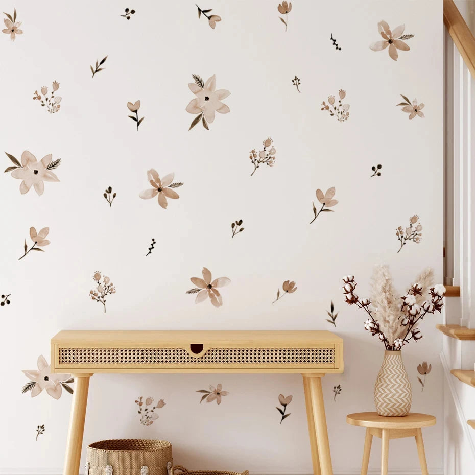 Wall with floral decals, wooden table, and decorative items in a room.
