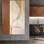 Abstract art piece on a wall next to a modern kitchen setup.
