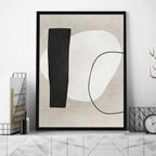 Abstract art print with black and white shapes in a modern interior setting